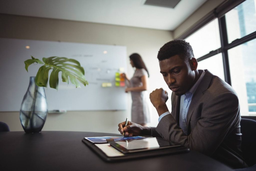 businessman using tablet in a training session | Business Training Programs | Zircon Consultants